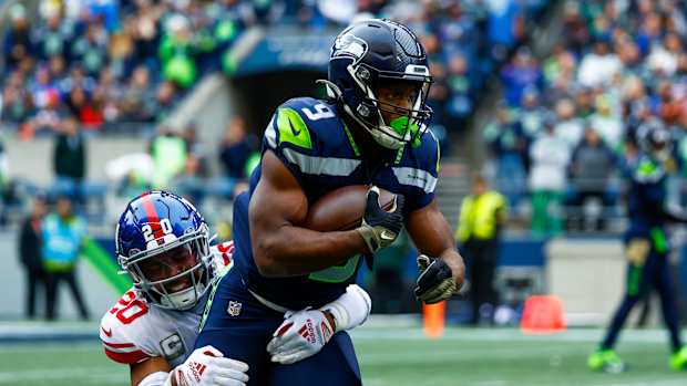 New York Giants safety Julian Love (20) tackles Seattle Seahawks running back Kenneth Walker III (9) on a rushing attempt during the first quarter at Lumen Field.